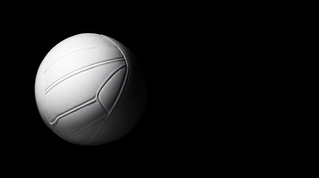 A captivating image of a white volleyball set against a black background, showcasing its intricate texture and design, perfect for sports-related projects and promotions.の素材