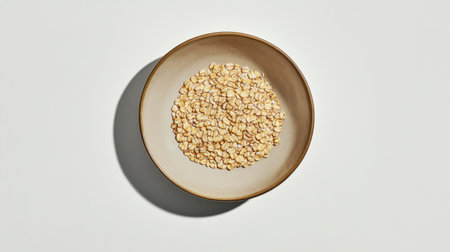 A close-up view of organic rolled oats presented in a bowl, perfect for promoting healthy eating, meal ideas, and nutritious recipes in food photography and culinary content.の素材