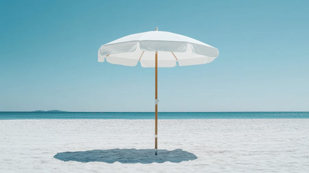 A picturesque beach scene featuring a white beach umbrella standing alone on soft white sand, with a clear blue sky and tranquil ocean waves in the background, inviting relaxation.の素材