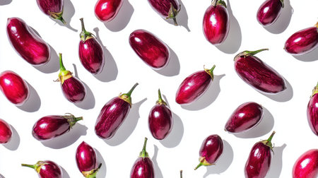 A visually appealing arrangement of fresh purple eggplants on a clean white surface, ideal for use in food-related projects, gardening themes, or healthy lifestyle presentations.の素材