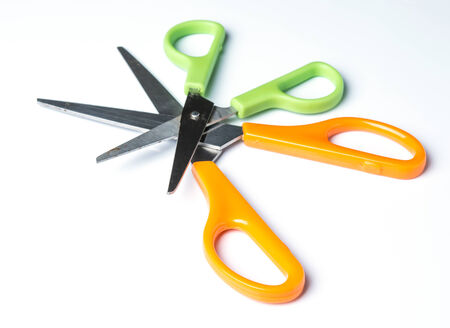 Green and orange scissors isolated on white backgroundの写真素材