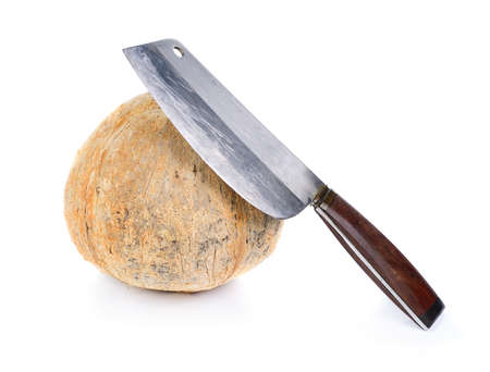 peel coconut with big knife isolated on whiteの写真素材