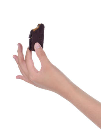 female hand holding chocolate biscuits isolated on white backgroundの写真素材