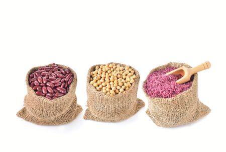mung beans, purple rice and soybean on white backgroundの写真素材