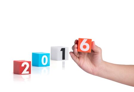 hand holding colorful plastic of year numbers on a white backgroundの写真素材