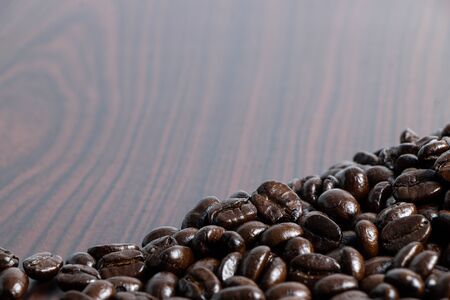 Coffee beans on brown wood laminate flooringの写真素材