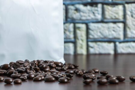 Coffee beans bought in a bag, wooden floor, photographed from the front, close up, back, blurredの写真素材