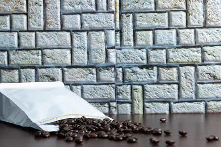 Coffee beans bought in a bag, wooden floor, photographed from the front, close up, back, blurredの写真素材