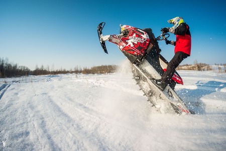 Khabarovsk, Russian - march 19, 2015 : a man rides his snowmobile in snowy fieldのeditorial素材