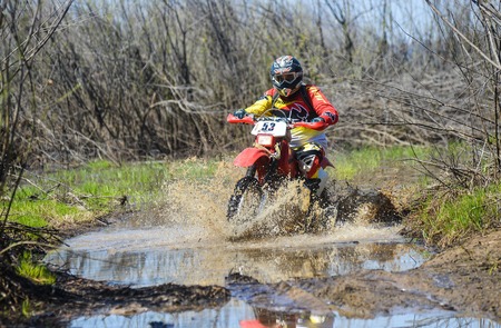 Khabarovsk , Russia - may 10, 2015 : Enduro motorcycle rides through the mud with a big splash at Khabarovsk rally - 2015のeditorial素材