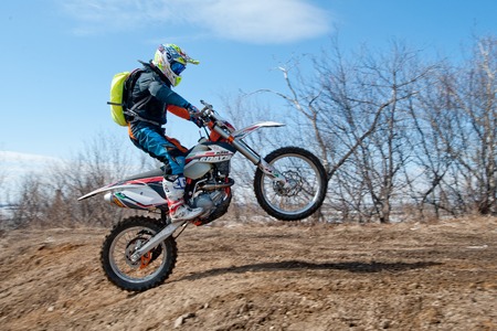 Khabarovsk , Russia - march 22, 2014 : Enduro motorcycle extreme rides on the rear wheelのeditorial素材