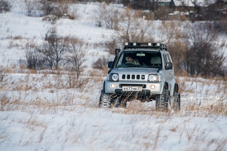 Khabarovsk, Russian - February 19, 2016 : car Suzuki Jimny rides through the snow on tracks in winterのeditorial素材