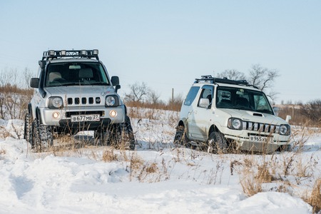 Khabarovsk, Russian - February 19, 2016 : car Suzuki Jimny rides through the snow on tracks in winterのeditorial素材