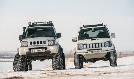 Khabarovsk, Russian - February 19, 2016 : car Suzuki Jimny rides through the snow on tracks in winterのeditorial素材