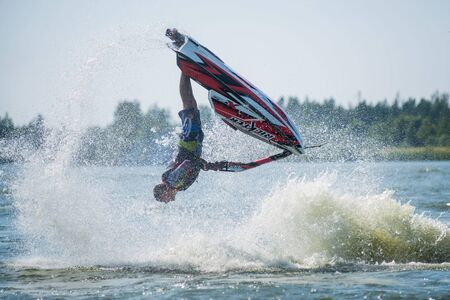 Khabarovsk, Russia - July 28, 2015: Man on jet ski turns with much splashesのeditorial素材