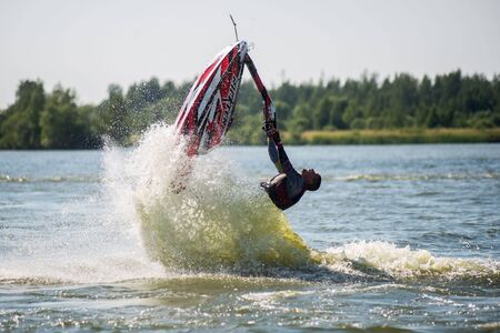 Khabarovsk, Russia - July 28, 2015: Man on jet ski turns with much splashesのeditorial素材