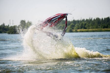 Khabarovsk, Russia - July 28, 2015: Man on jet ski turns with much splashesのeditorial素材