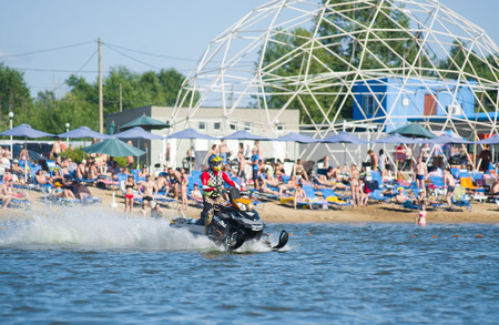 Khabarovsk, Russia - July 28, 2015: man on snowmobile goes fast on the water in summerのeditorial素材