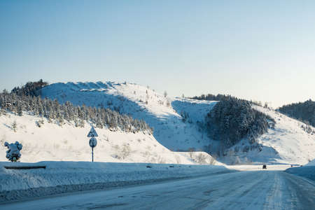 Road covered with snow winter snow mountainsの写真素材