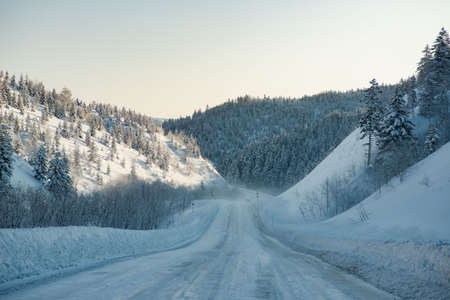 Road covered with snow winter snow mountainsの写真素材