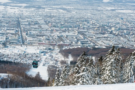 Russia Yuzhno-Sakhalinsk Jan 10, 2014 : View of city and gondola lift system at Gorny Vozdukh ski resort which serves as mass transportation to tourist and visitors.のeditorial素材