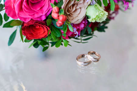 Beautiful wedding bouquet of flowers in hands of the bride wedding bouquet and ringsの写真素材