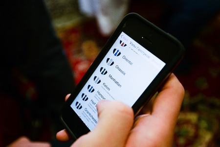 Hands chained holding smartphone phone to tie a tieの写真素材