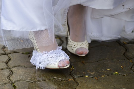 close up view of woman putting some shoe on shoes brideの写真素材