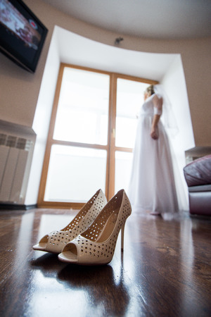 close up view of woman putting some shoe on shoes brideの写真素材