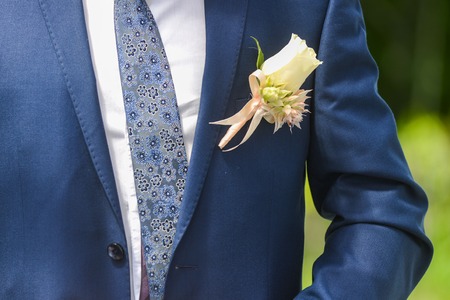 flower boutonniere for the groom in the wedding day