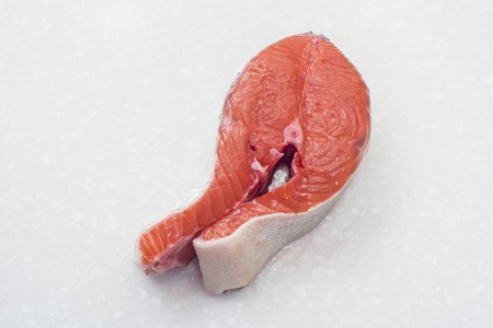 raw salmon fillet isolated on white background for cookingの写真素材