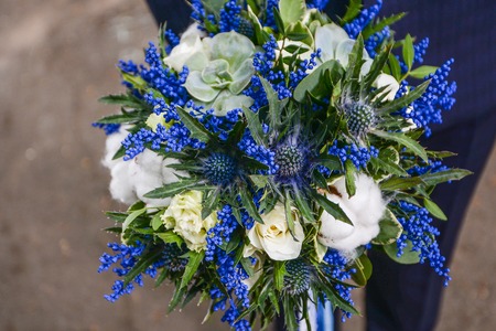 Beautiful wedding bouquet of flowers in hands of the bride wedding bouquet and ringsの写真素材