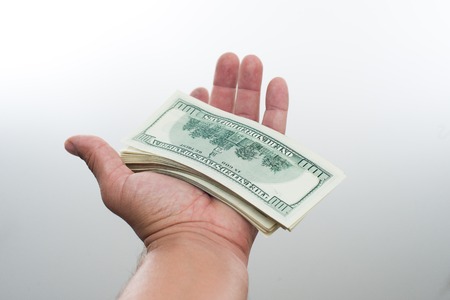 men believes the dollars in hand on white backgroundの写真素材