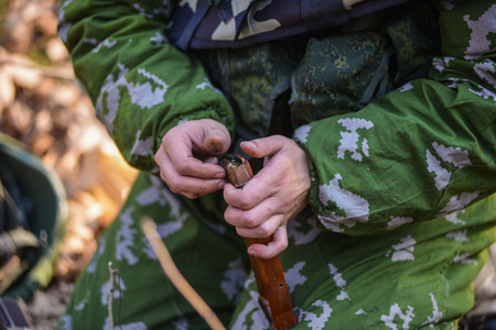 Russian soldiers charging machine cartridges close up