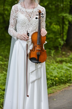 Girl playing a violin on green backgroundの写真素材
