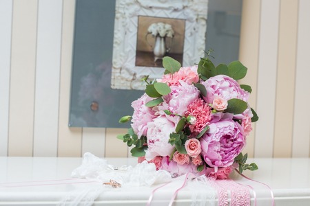 Beautiful wedding bouquet and rings flowers peoniesの写真素材