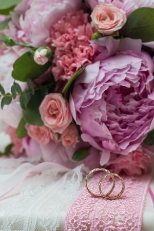 Beautiful wedding bouquet and rings flowers peoniesの写真素材