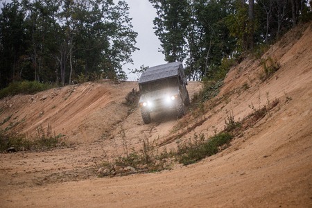 VLADIVOSTOK, RUSSIA - SEPTEMBER 22, 2015: Motor car Toyota Mega Cruiser driving on a forest roadのeditorial素材