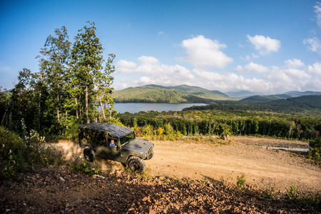 VLADIVOSTOK, RUSSIA - SEPTEMBER 22, 2015: Motor car Toyota Mega Cruiser driving on a forest roadのeditorial素材