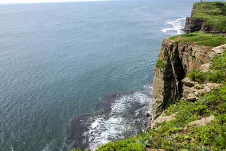 blue sky, high cliffs, the waves of the sea