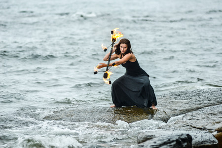 play with fire show on the shore of the seaの写真素材