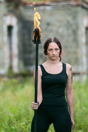 Fire show girl with flaming torchesの写真素材
