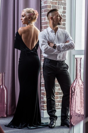 Young beautiful couple in a suit and evening gownの写真素材