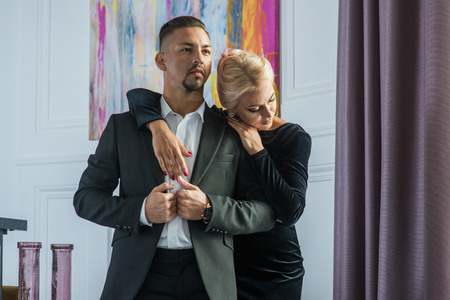 Young beautiful couple in a suit and evening gownの写真素材