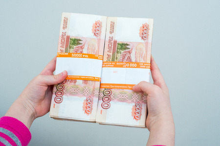 closeup humans hands holding russian rublesの写真素材