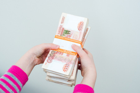 closeup humans hands holding russian rublesの写真素材