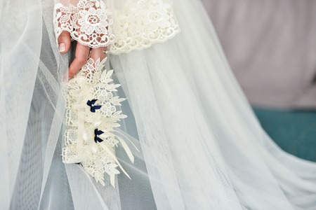 Garter on the leg of a bride, Wedding day momentsの写真素材