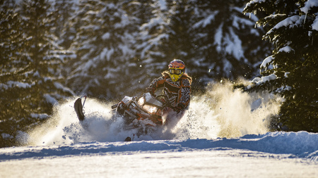 Rider on the snowmobile in the mountains ski resort in Sakhalin island
