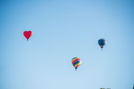 Hot-air balloons in the cloudy blue skyの写真素材