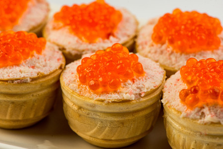 Tartlets with cheese and red caviar. Selective focus. Copy spaceの写真素材